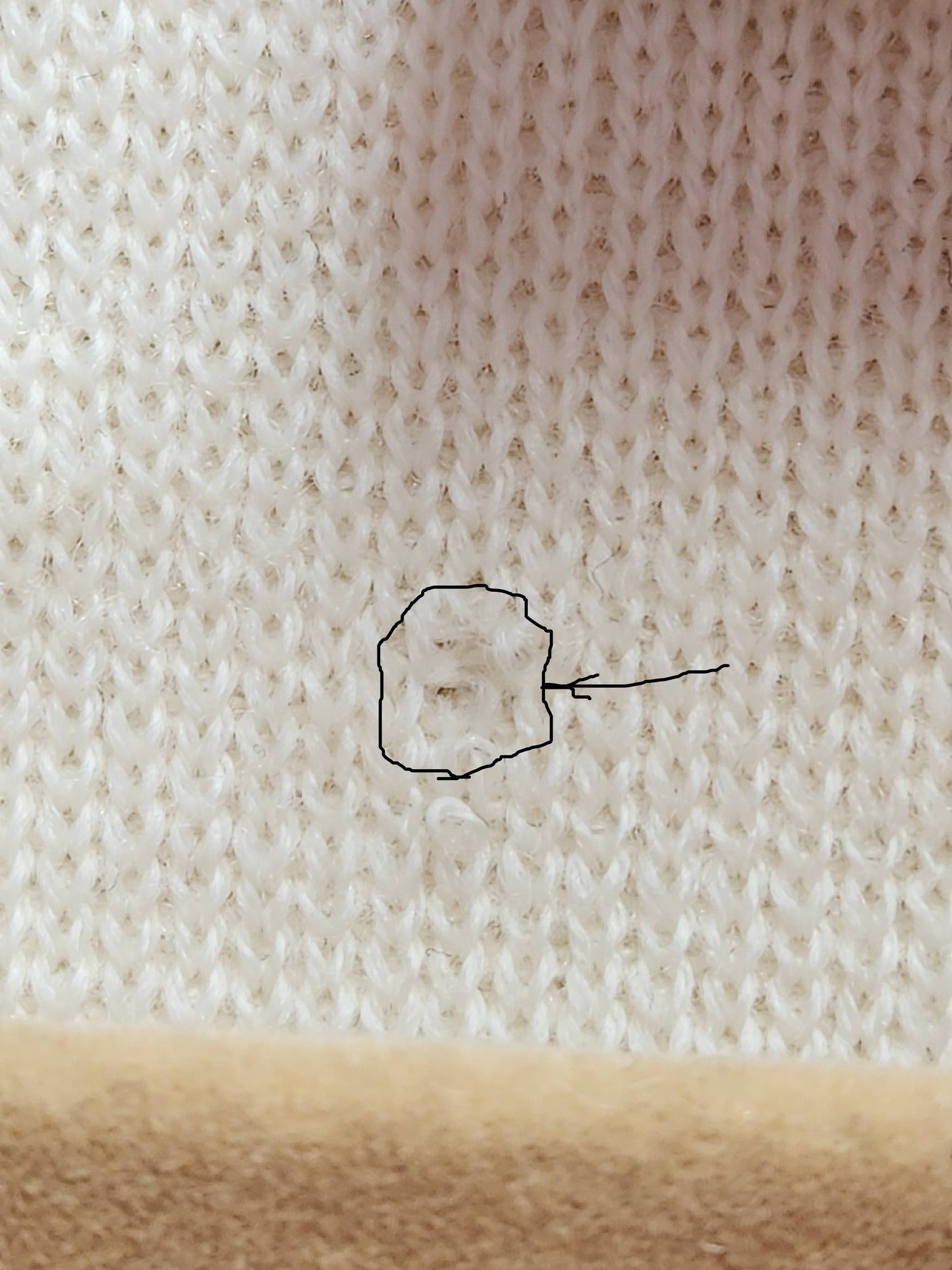 tiny hole on inside below size tag