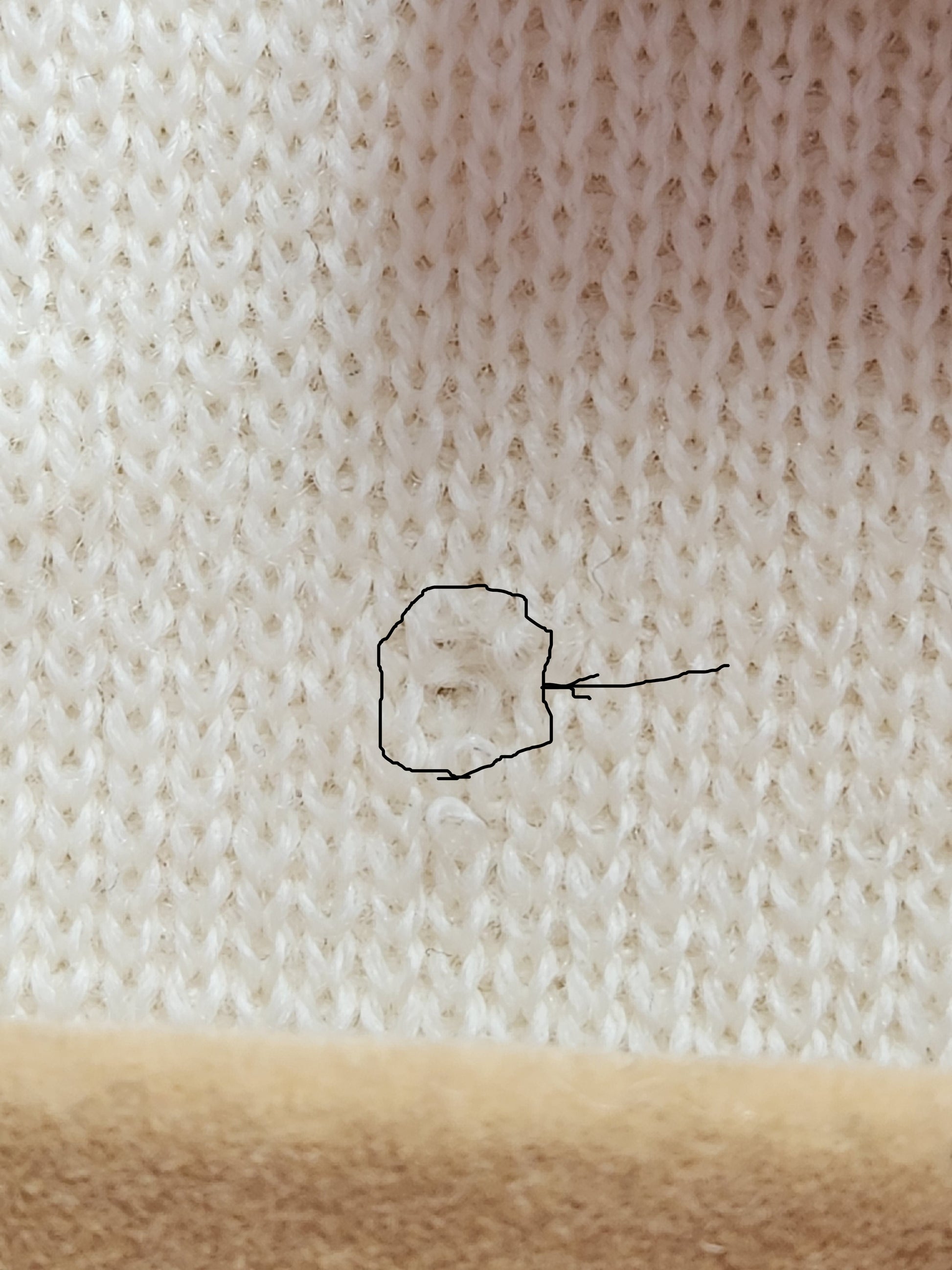 tiny hole on inside below size tag